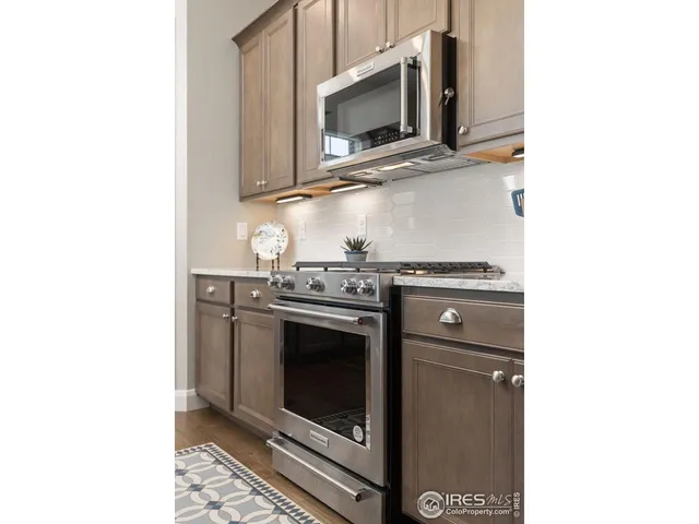 a stove top oven sitting inside of a kitchen