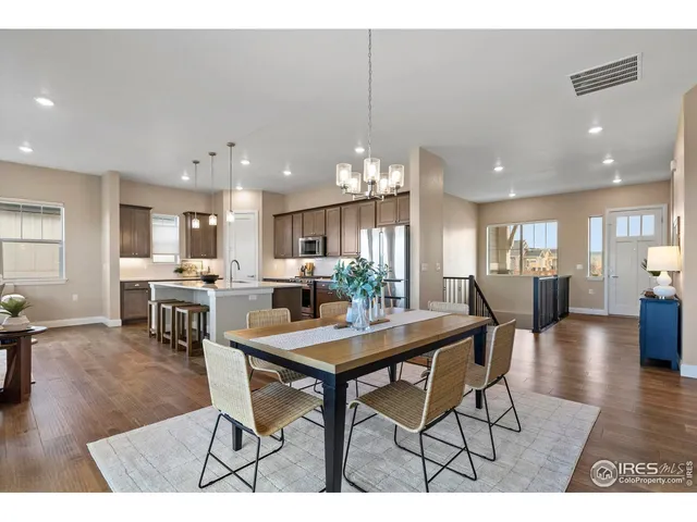 a kitchen with a dining table chairs and view of living room
