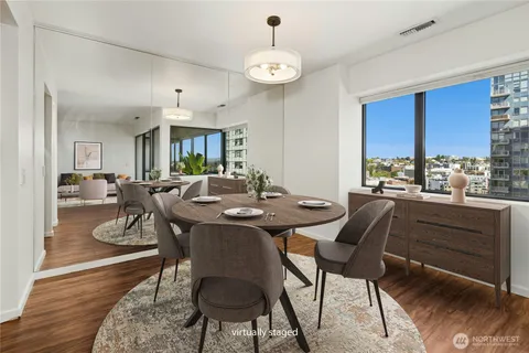 a view of a dining room with furniture window and wooden floor