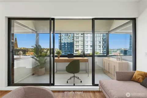 a living room with furniture and a floor to ceiling window