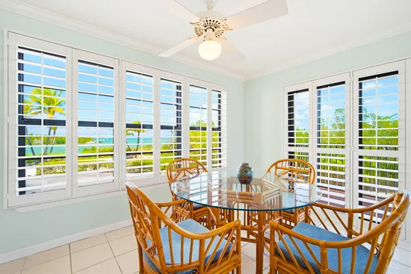 a dining room with furniture a chandelier and wooden floor