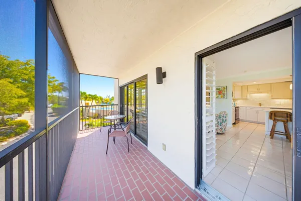 a view of a balcony with wooden floor