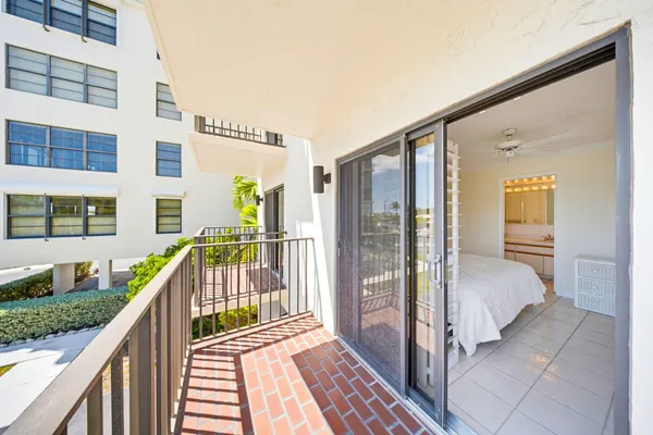 a view of a balcony with wooden floor and fence