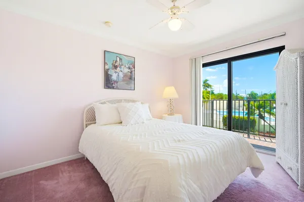 a bedroom with a large bed and a large window
