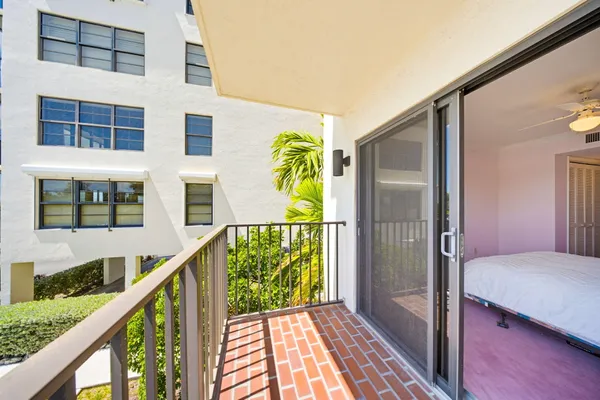 a view of balcony with wooden floor and potted plants