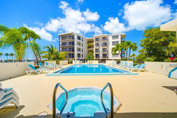 a view of a building with a garden and pathway