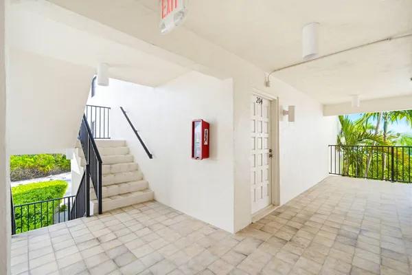 a view of hallway with furniture and a window