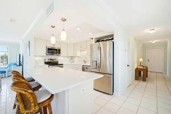 a kitchen with stainless steel appliances a refrigerator sink and cabinets