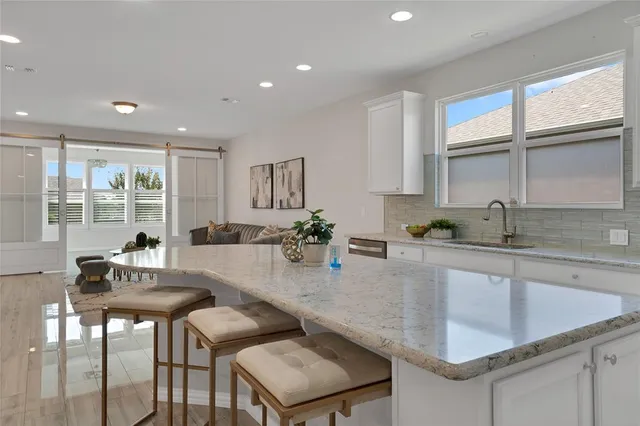 a kitchen with a dining table chairs and window