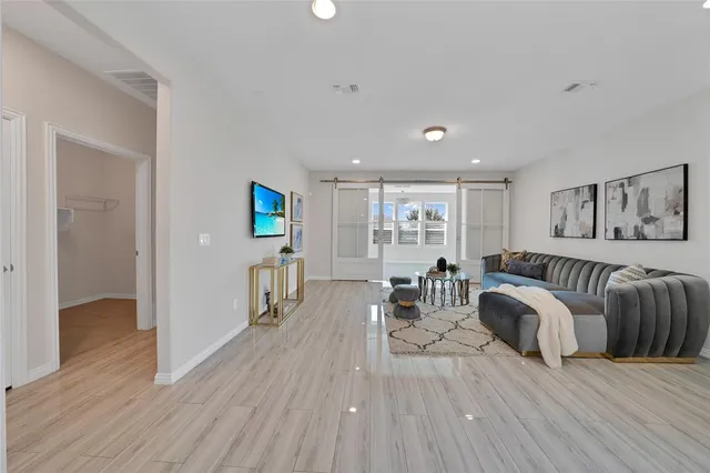 a living room with furniture and a wooden floor
