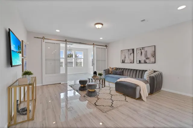 a living room with furniture and a wooden floor