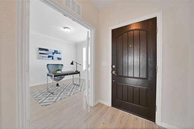 a living room with furniture and a kitchen view