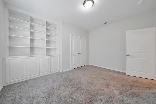 a view of an empty room with a closet