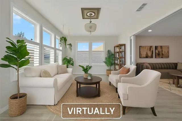a living room with furniture potted plant and a window