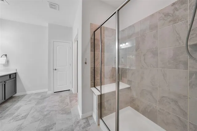 a bathroom with a shower and a sink