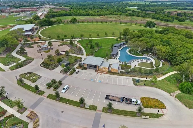 an aerial view of a house with a garden and lake view