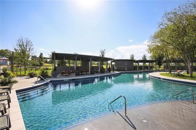 a view of swimming pool with a patio and a yard