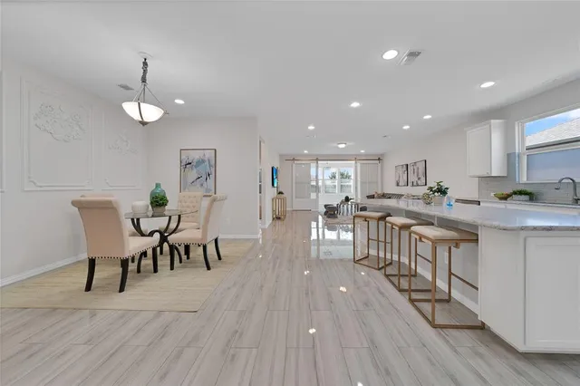 a view of a dining room with furniture wooden floor and a rug