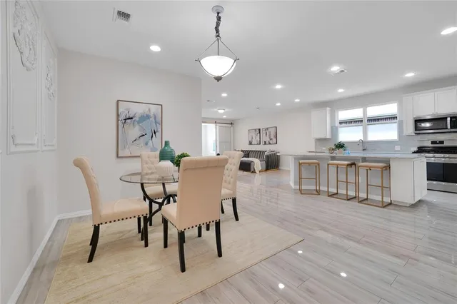 a living room with stainless steel appliances kitchen island granite countertop furniture and a kitchen view