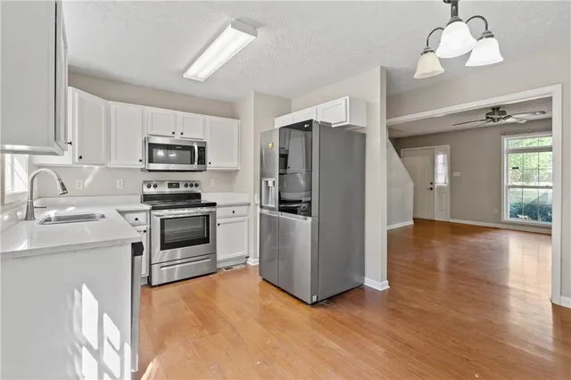 a kitchen with stainless steel appliances a refrigerator stove and sink