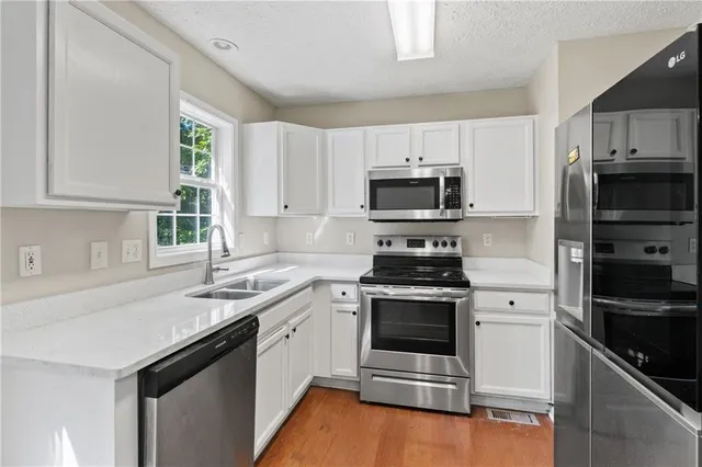 a kitchen with a sink stove and microwave