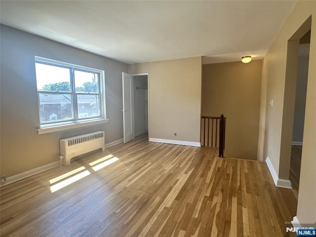 460 Heath Place, Unit 48 Hackensack, NJ 07601 - Photo 4 of 10 a view of a room with wooden floor and windows