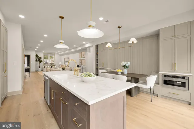 a kitchen with stainless steel appliances granite countertop a stove a sink dishwasher and a refrigerator with wooden floor