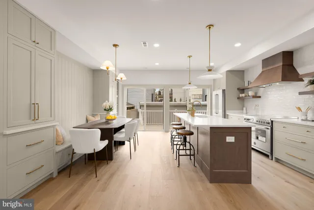 a kitchen with stainless steel appliances granite countertop a lot of counter space and wooden floors