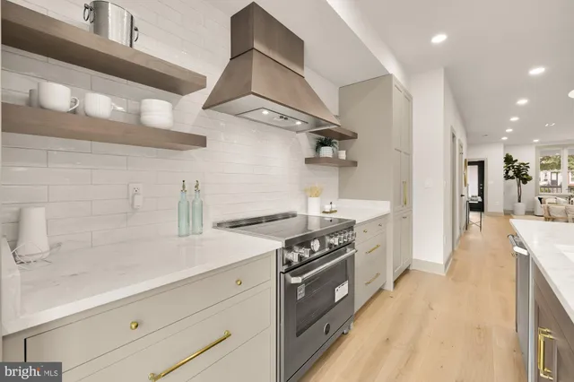 a kitchen with stainless steel appliances granite countertop a stove and a sink