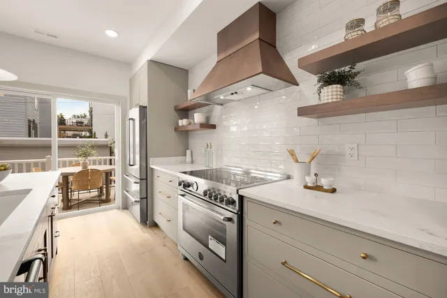 a kitchen with kitchen island a stove a table and chairs in it