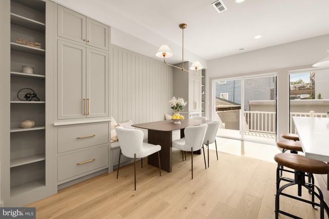 a view of a balcony with wooden floor and outdoor seating