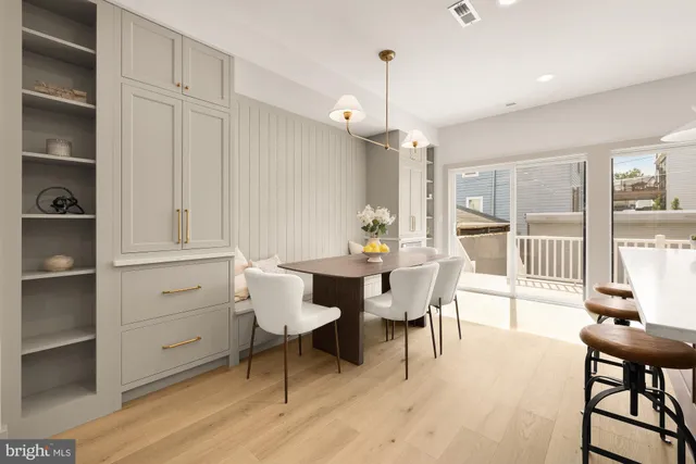 a view of a balcony with wooden floor and outdoor seating