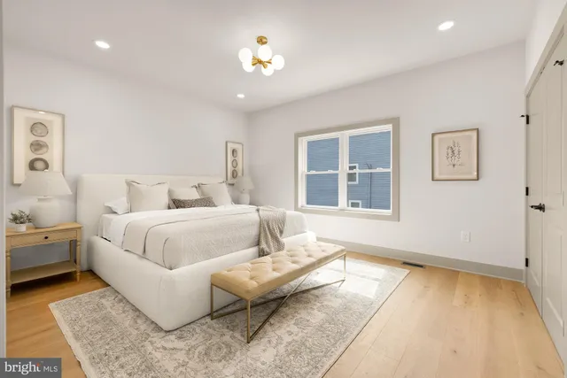 a bedroom with a bed and wooden floor