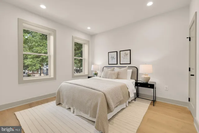 a bedroom with a bed and a night stand