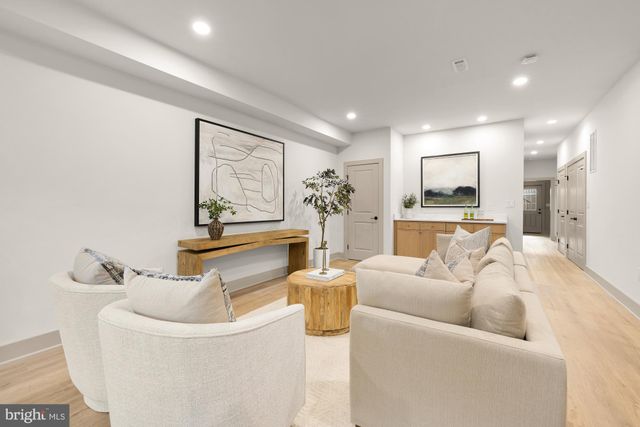 a spacious bedroom with a bed and wooden floor