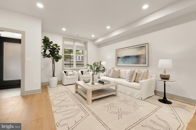a living room with furniture and a large mirror