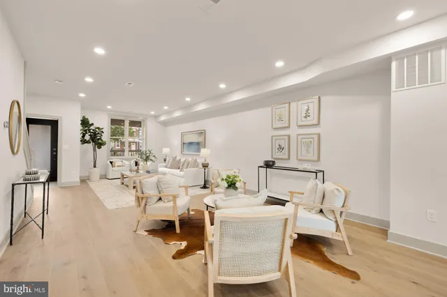 a kitchen with kitchen island granite countertop lots of white cabinets stainless steel appliances and dining table