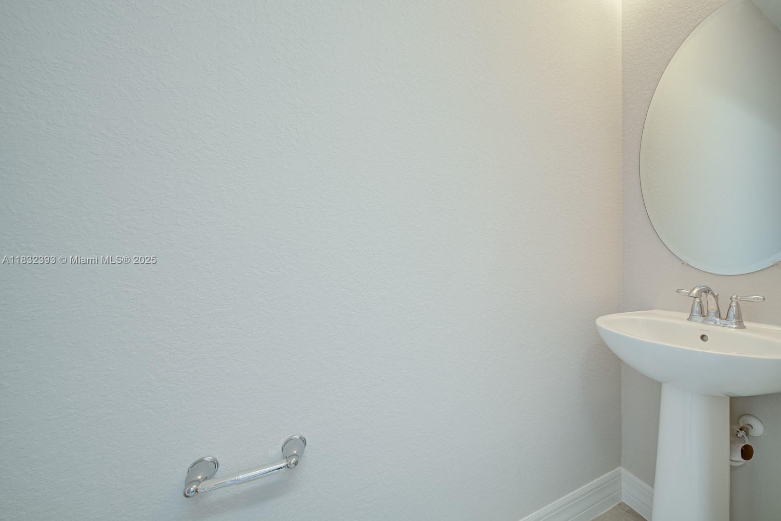 1280 Eucalyptus Drive, Unit 4 Hollywood, FL 33021 - Photo 21 of 36 a bathroom with a sink and a mirror