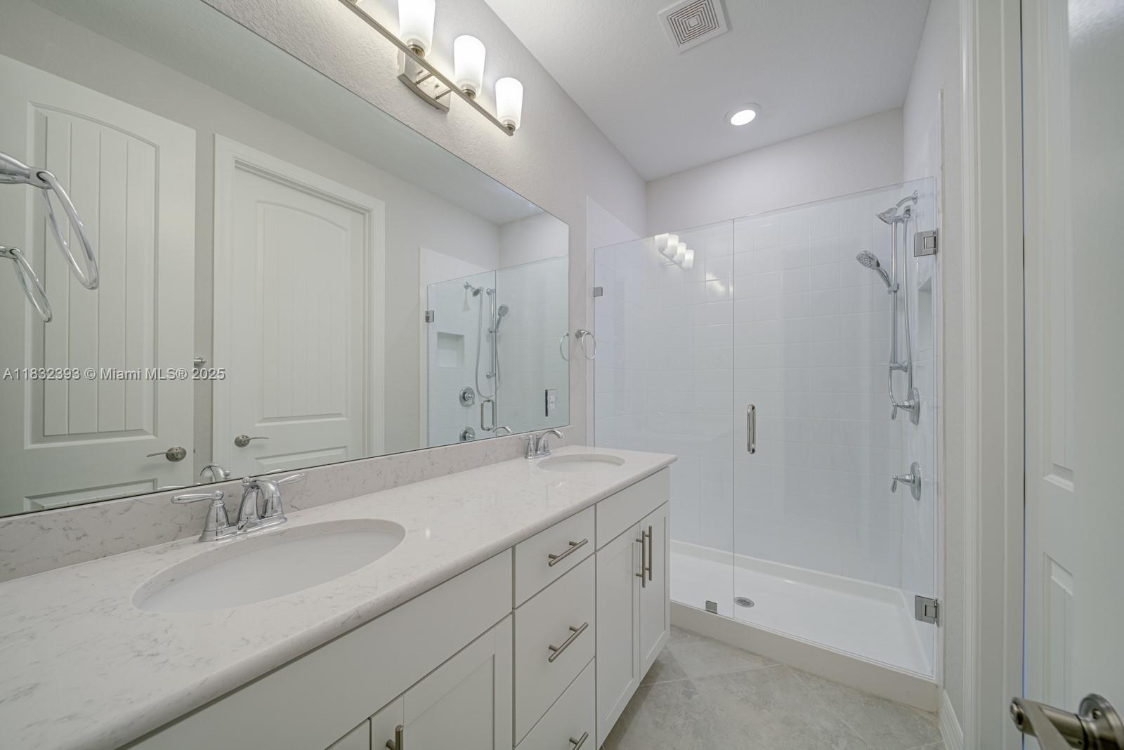 1280 Eucalyptus Drive, Unit 4 Hollywood, FL 33021 - Photo 3 of 36 a bathroom with a sink double vanity granite tub and shower