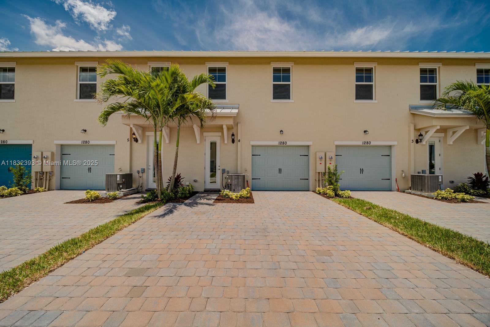 1280 Eucalyptus Drive, Unit 4 Hollywood, FL 33021 - Photo 33 of 36 a front view of a house with a yard and a garage