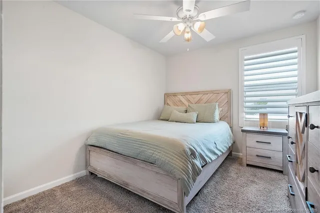 a bathroom with a granite countertop sink toilet and a mirror