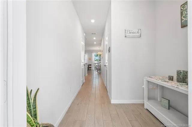 a view of a hallway with wooden floor