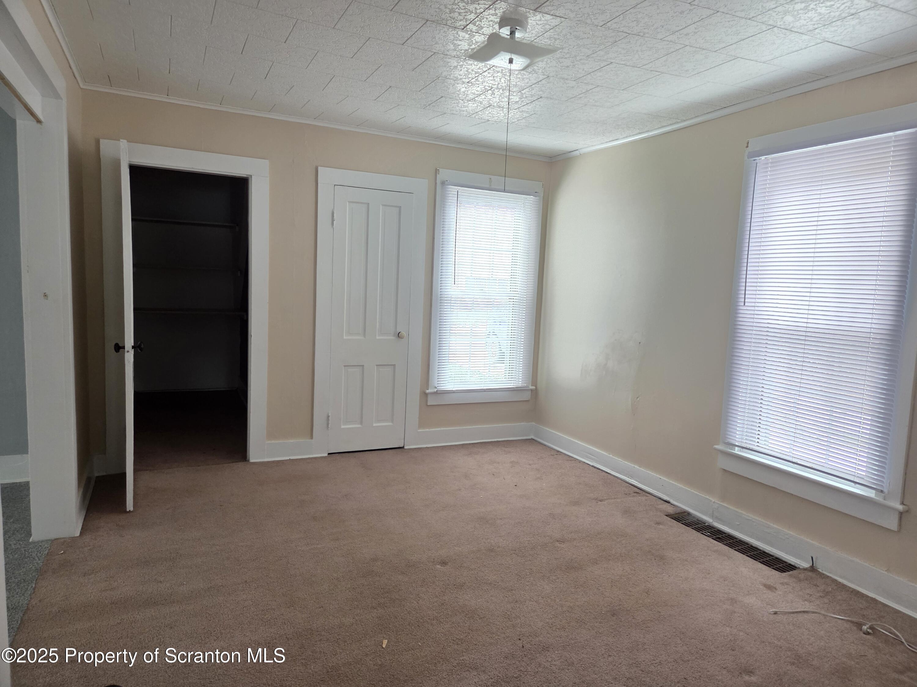 5 East Harrison Street Tunkhannock, PA 18657 - Photo 20 of 25 an empty room with windows and closet