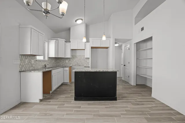 a kitchen with a refrigerator and a sink