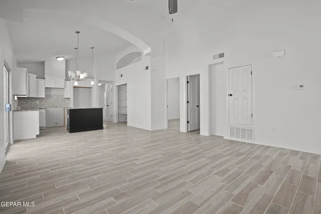 a view of a kitchen with a microwave and wooden floor