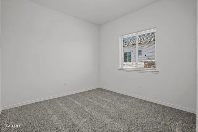 a bedroom with a large bed and a potted plant