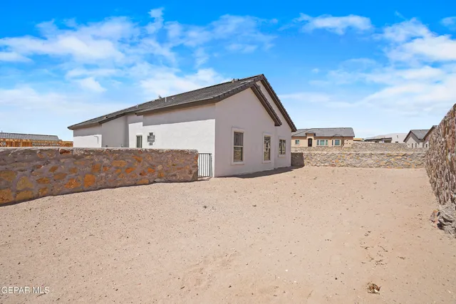 a view of a dry yard with a house