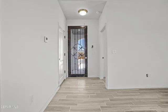 a view of a hallway with wooden floor and closet