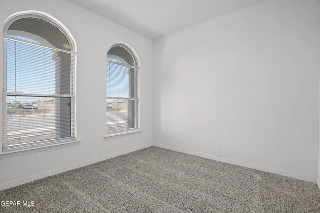 an empty room with windows and closet