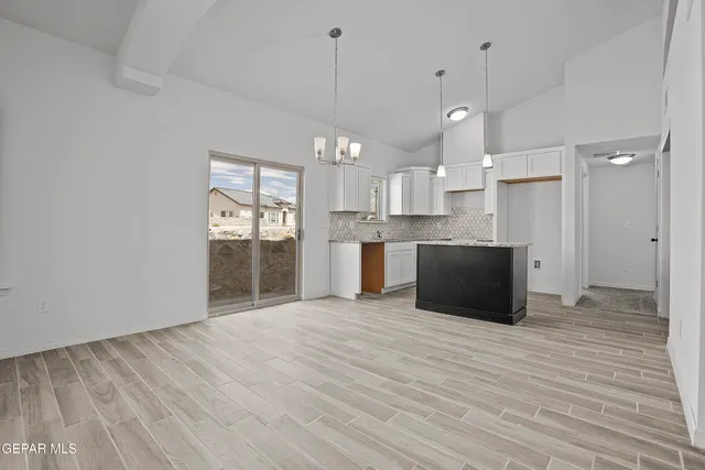 a view of a kitchen with a sink and a refrigerator